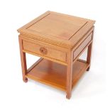 A Chinese hardwood occasional table, of square section, with single frieze drawer, raised on