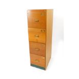 A Stoltenberg Buromobel mid 20thC oak filing cabinet, of four drawers, raised on a plinth base,