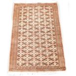 A Persian design rug, with four rows of medallions on a red ground with three narrow borders,