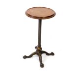 A Victorian oak and cast iron circular revolving occasional table, raised on an embossed iron column