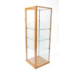 An early 20thC oak shop display cabinet, of square section, with glass top and four glass sides, the