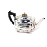 A George III silver semi fluted teapot, raised on four ball feet, Joseph Guest, London 1811, 20.