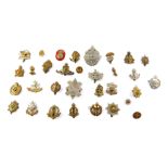 Brass and white metal military cap badges, including South Staffordshire Regiment, Gloucestershire