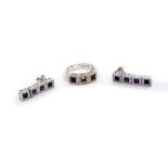 A Zoccai 18ct white gold sapphire and diamond ring, the three square cut sapphires in a surround