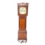 A Georgian mahogany and oak longcase clock, the square enamelled metal dial painted with figures,