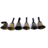 Six hand bells with hammers, tooled leather handles.