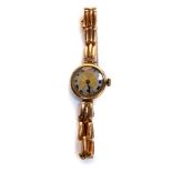 A mid 20thC lady's 9ct gold cased wristwatch, circular cased with engine turned gold and silver