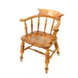 A Victorian oak and elm smokers bow chair, with a solid saddle seat, raised on turned legs, united