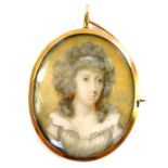 A late 18thC portrait miniature of a lady, in an oval gilt metal pendant mount, with brooch pin