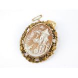 A late 19thC European cameo brooch, carved with figures in a landscape with castle, set in yellow