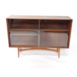 A Dalescraft 1960's teak bookcase, of rectangular section, with two glazed doors opening to reveal