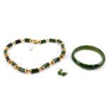 A 14ct gold and jade necklace, of curved barrel formed links, on a cabachon set clasp with safety