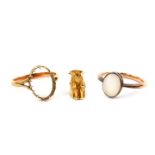 A 9ct gold charm modelled as a Toby jug, 9ct gold and moonstone set ring, and a further ring