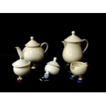 A Carltonware lustre pottery 'Walking' teapot, hot water jug, milk jug and two sugar basins with