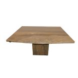 An Italian brown travertine marble dining table, the rectangular top raised on a rectangular block