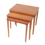 A 1970's teak nest of occasional tables, raised on cylindrical legs, largest table 49cm H, 55cm W,