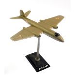 A cast metal mid 20thC desk stand modelled as a Canberra bomber, on a ball and socket column, and