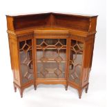 A Victorian mahogany corner bookcase, in the manner of Jas Shollbred & Company, the dentil moulded