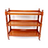 A Victorian mahogany buffet, with three tier shelves, raised on fluted and turned supports, on