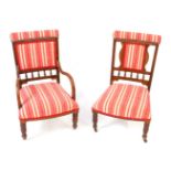 A Victorian walnut nursing carver chair, with red and white striped fabric back and overstuff