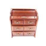 An oak jewellery cabinet, modelled as a tambour fronted chest, with six small drawers, 23cm H, 20.