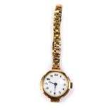 A Buren ladies 9ct gold circular cased wristwatch, white enamel dial bearing arabic numerals,