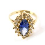 An Alexandrite set ring, the marquise blue centre stone in a surround of brilliant white stones,