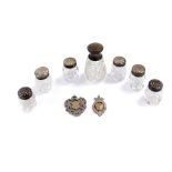 A George V cut glass and silver lidded scent bottle, Birmingham 1925, six cut glass pepperettes,