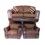 A purple leather and fabric three piece suite, comprising two seater sofa, recliner armchair and a