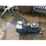 A Hayter Harrier 48 petrol lawn mower, with electric start and Briggs & Stratton motor, with keys.