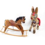 A child's rocking horse, 106cm L, together with a Spanish donkey soft toy, 102cm H. (2)