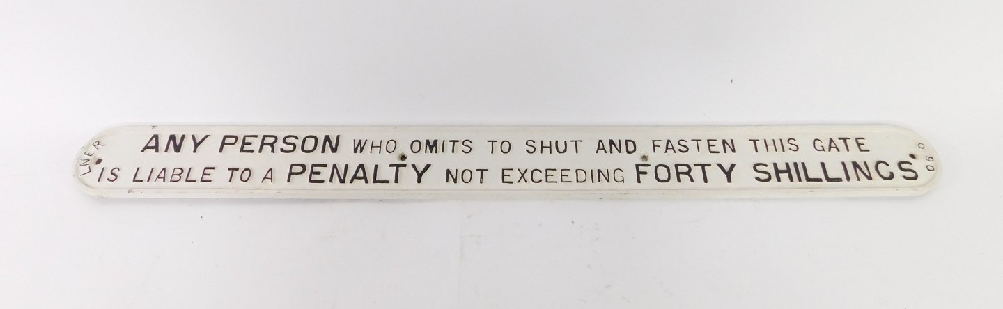 An LNER cast iron sign, with wording in relief, inscribed Any Person Who Omits To Shut And Fasten