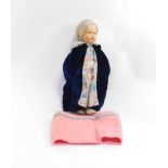 A Raynal of Paris doll, in a floral fronted and pink dress, blue cape with floral trim, hands