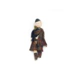 A Victorian bisque porcelain doll, modelled in Highland Dress, 26.5cm H.