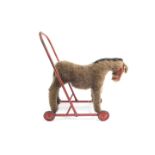 A Pedigree Pets Push Me Pull Me Donkey, on a red metal chassis, 48cm L.