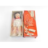 A Palitoy Petalskin vinyl doll, No 3701, with white dress and brunette wig, boxed.