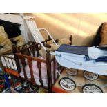 A doll's pram, two oak cots, and a Teddy Bear. (4)