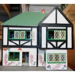 A 20thC wooden double fronted doll's house, modelled as a Mock Tudor house, together with furniture,