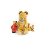 An early 20thC small jointed teddy bear, 14cm H, two further teddy bears, and a Care Bear, 46cm