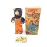 An Alps Japanese tin plate mechanical Cubby Bear, The Reading Bear, with integral key, boxed.