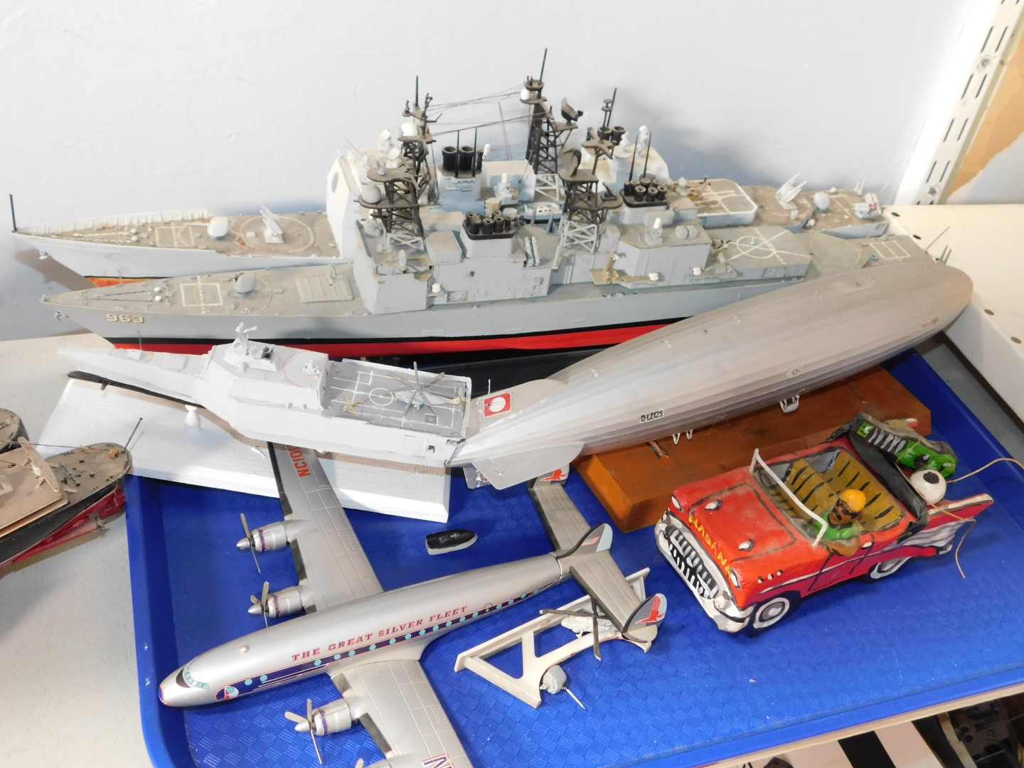 A model of The USS Ticonderoga, further American warship, Hindenburg airship, helicopter carrier,