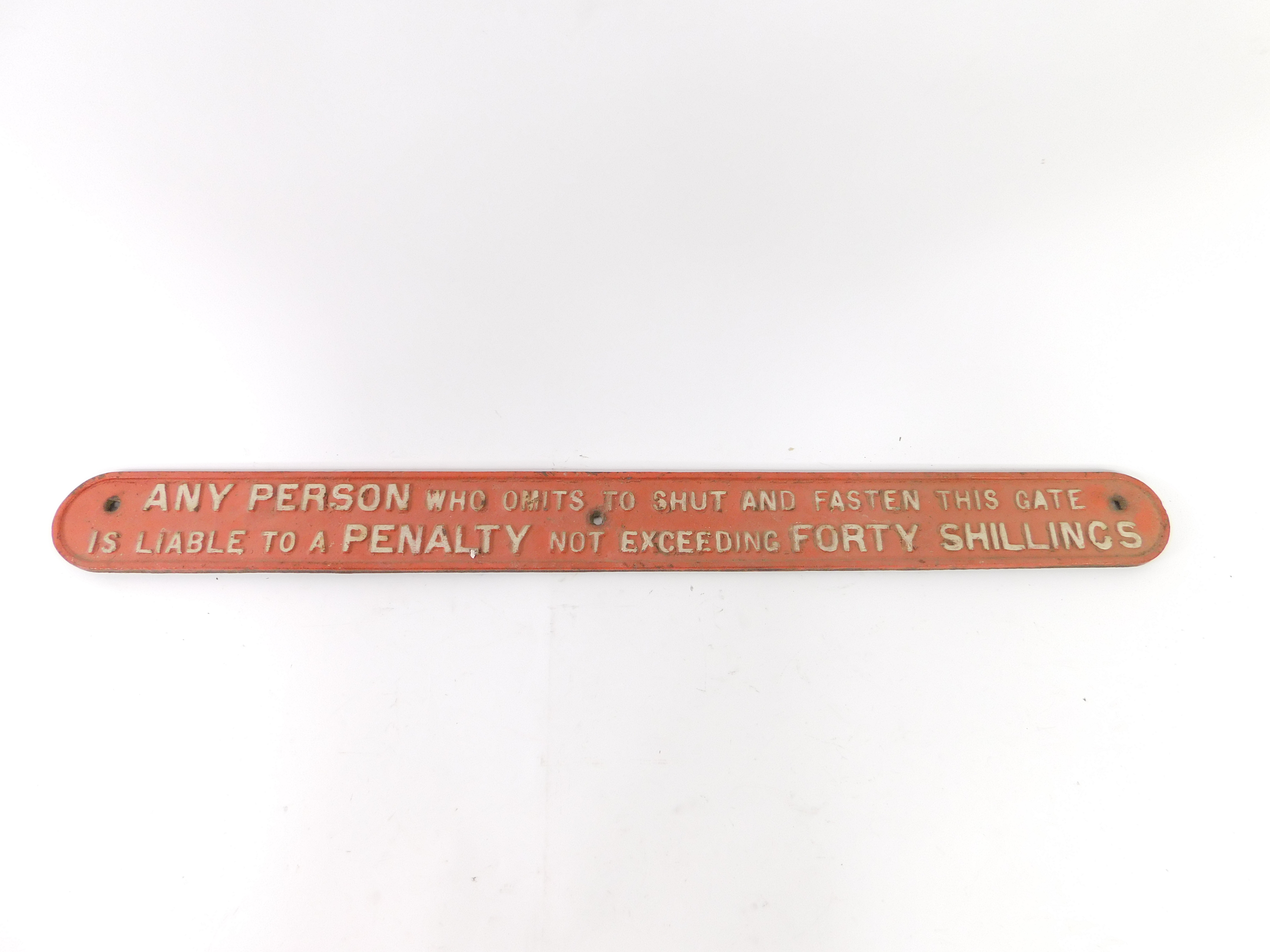 A vintage cast iron railway sign, inscribed Any Person Who Omits To Shut And Fasten This Gate Is