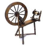 A modern pine and beech spinning wheel, on turned legs