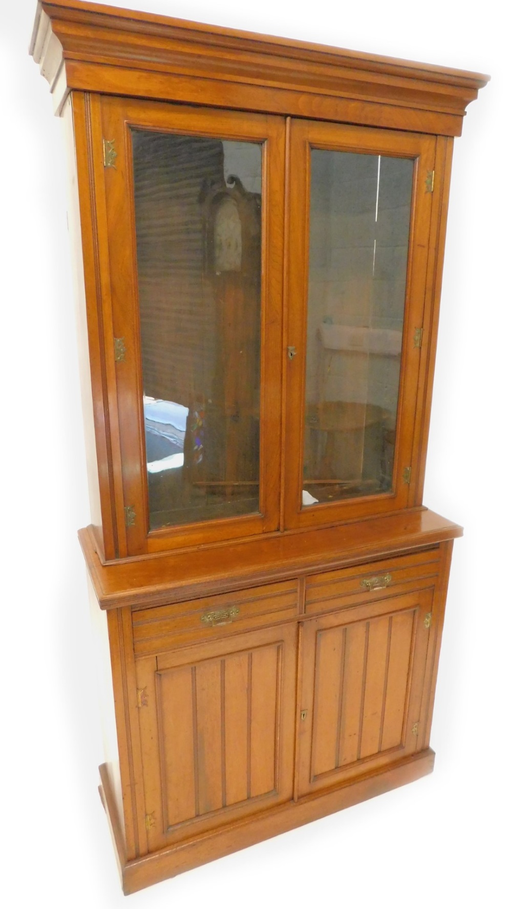 A Victorian walnut bookcase, the top with a moulded cornice, with two glazed doors, the base with