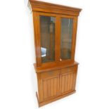 A Victorian walnut bookcase, the top with a moulded cornice, with two glazed doors, the base with
