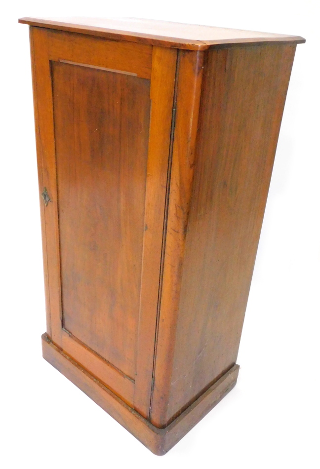 A 19thC walnut side cabinet, the top with a moulded edge above a panel door on plinth base, (AF),