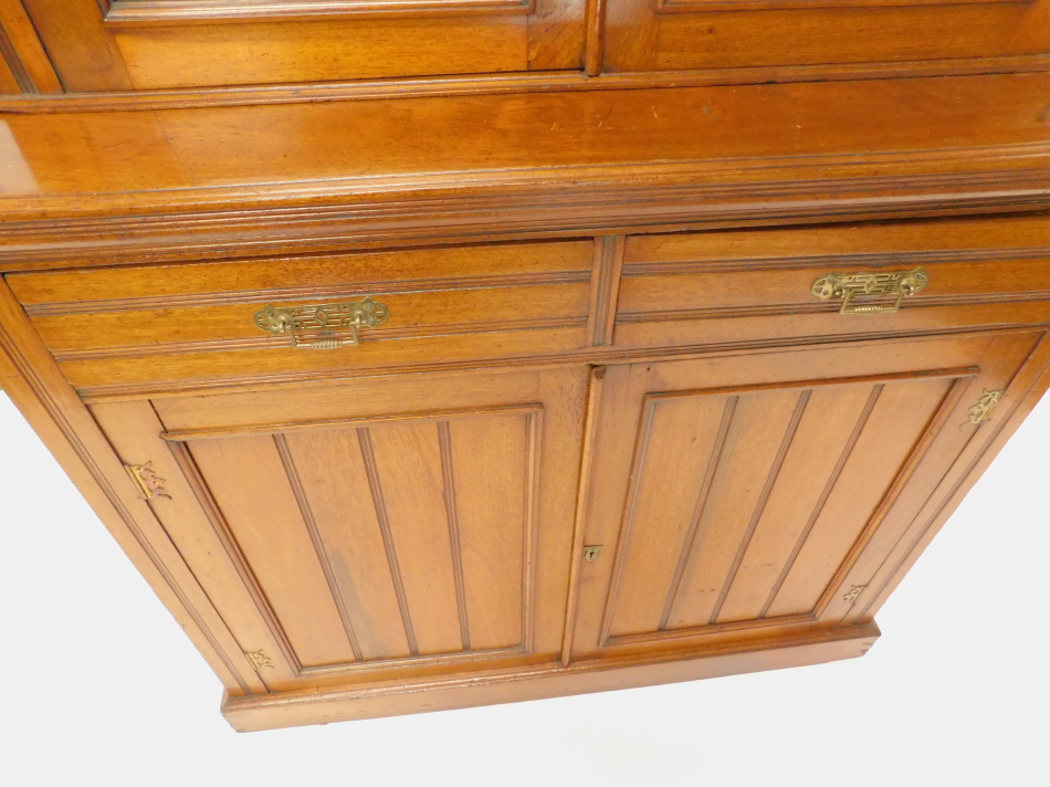 A Victorian walnut bookcase, the top with a moulded cornice, with two glazed doors, the base with - Image 2 of 2