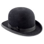 A bowler hat, with a label for A. Cheer and Sons of Boston, with super cushion fitting.