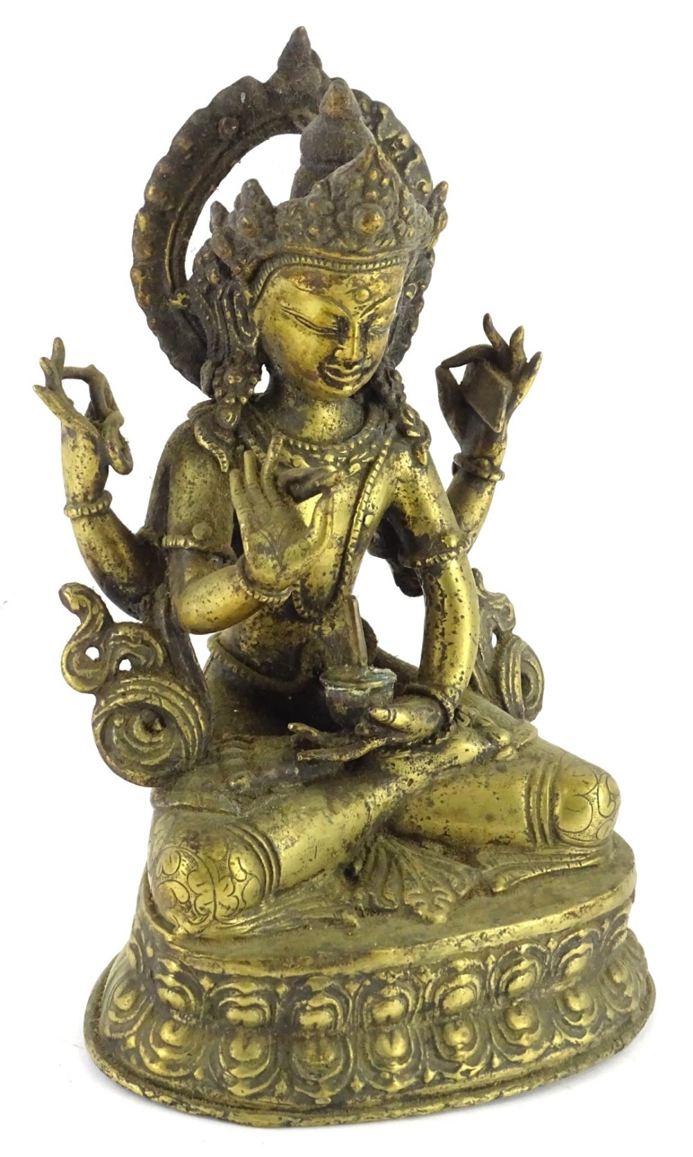 @An Indian gilt metal figure of a god in seated position.