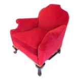 An early 20thC walnut armchair, re upholstered in red velvet on cabriole legs.